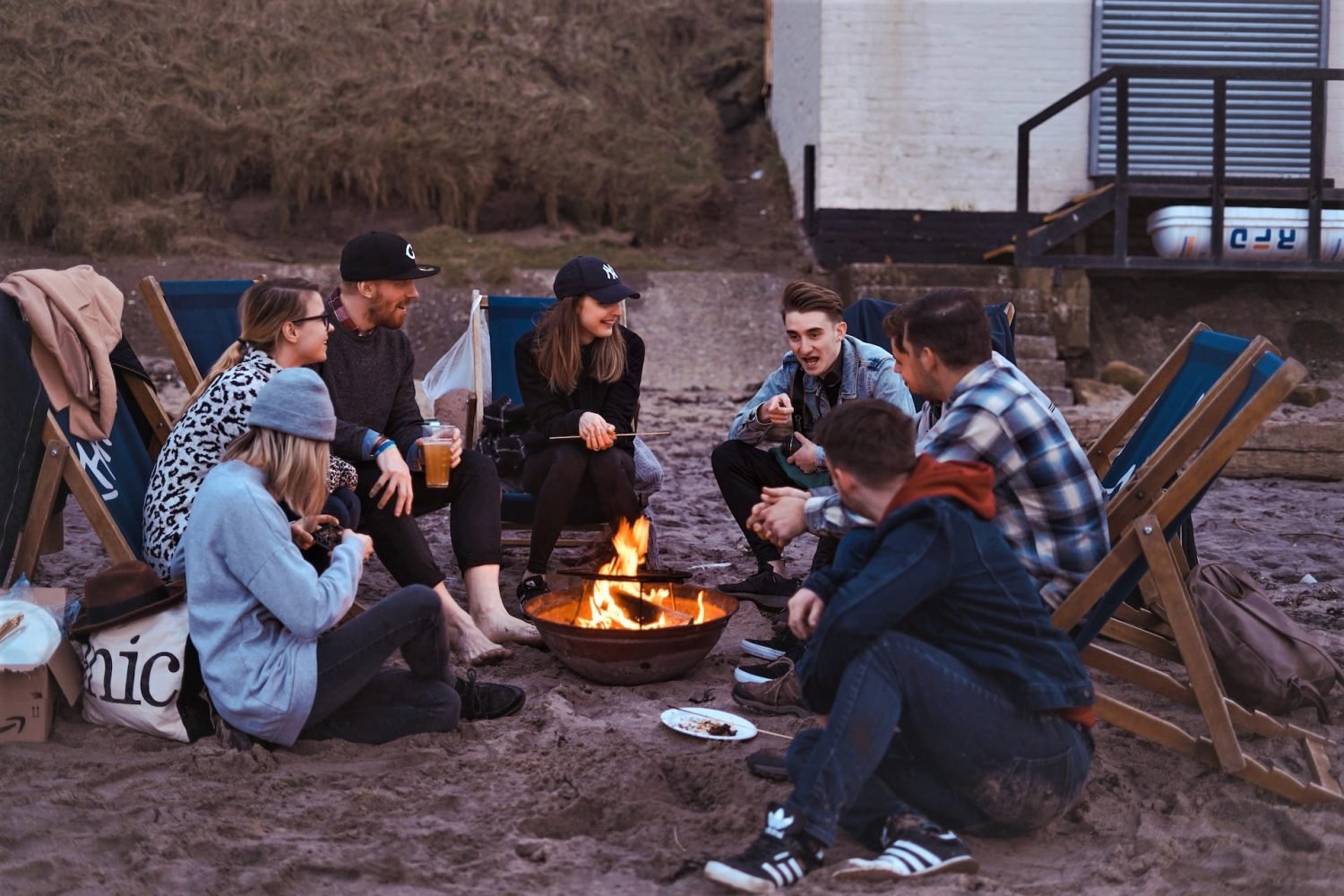 group of friends gathered around campfire